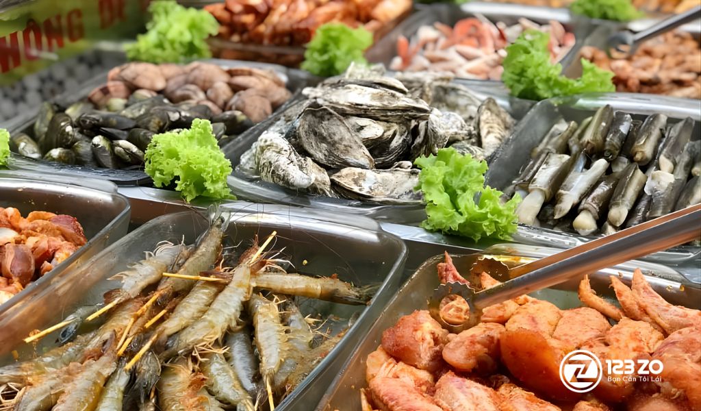 Quầy line buffet hải sản bình dân với hàu, tôm xiên que, nghêu, sò và cánh gà tại Buffet 123K.