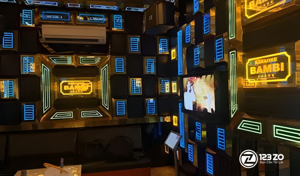 Phòng hát màu tím hồng lãng mạn với đèn trần pha lê và rèm cửa sang trọng tại quán karaoke Bambi Bình Thạnh.